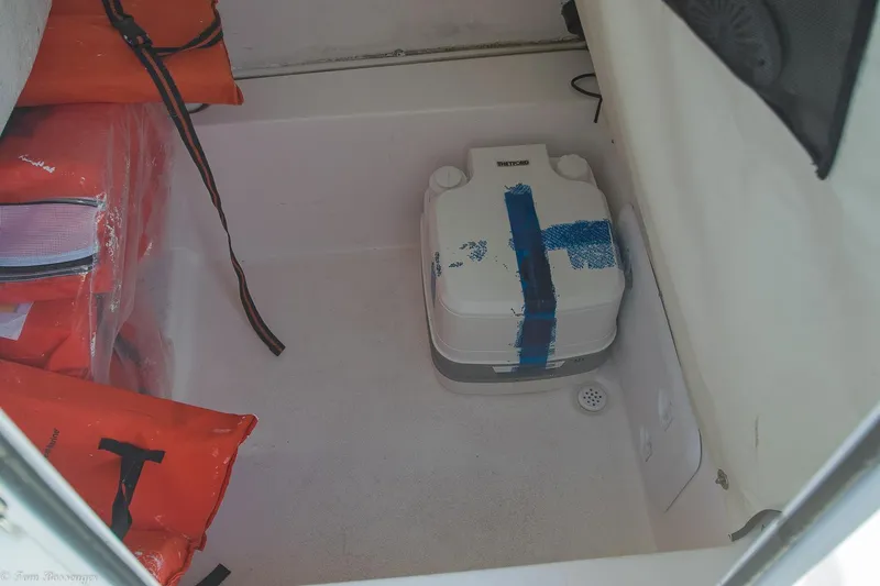 Slide: The Image of 2021 Sea Fox 248 Commander storage area with life jackets and portable toilet. - 31