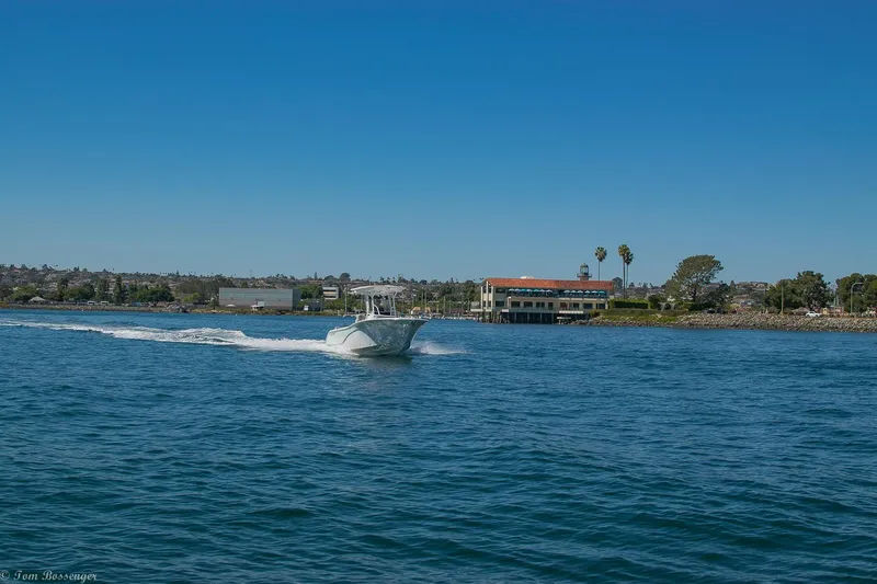 Slide: The Image of 2021 Sea Fox 248 Commander cruising on a sunny day near coastal buildings. - 32