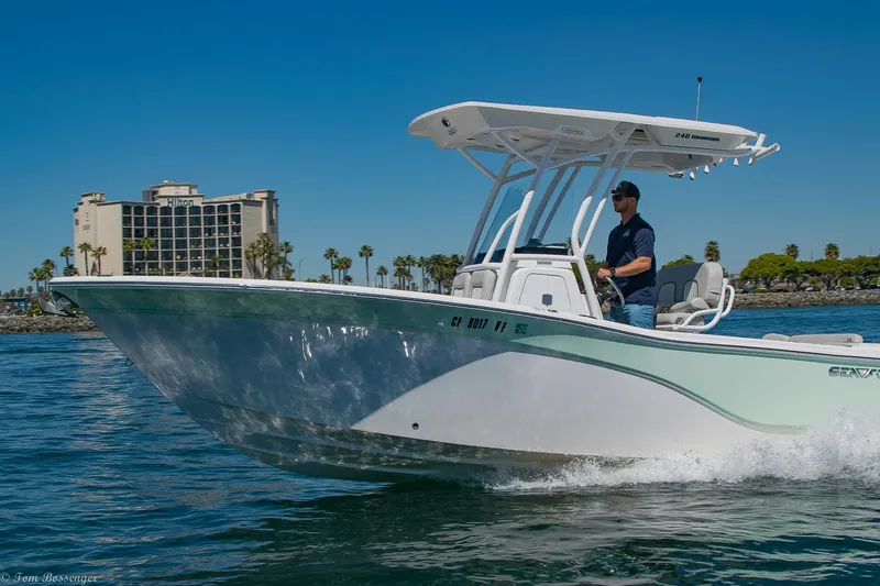 Slide: The Image of 2021 Sea Fox 248 Commander boat cruising on a sunny day near a coastal city. - 38