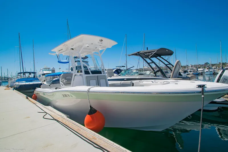 Slide: The Image of 2021 Sea Fox 248 Commander boat docked at marina under clear blue sky. - 4