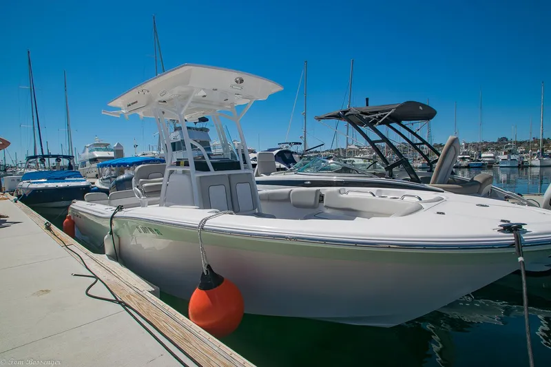 Slide: The Image of 2021 Sea Fox 248 Commander boat docked at marina under clear blue sky. - 7