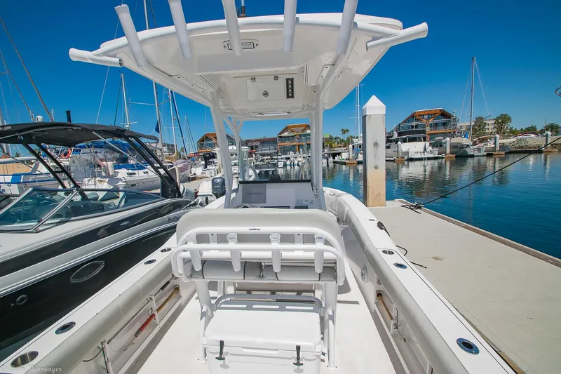 Slide: The Image of 2021 Sea Fox 248 Commander boat docked at a marina under clear blue skies. - 8