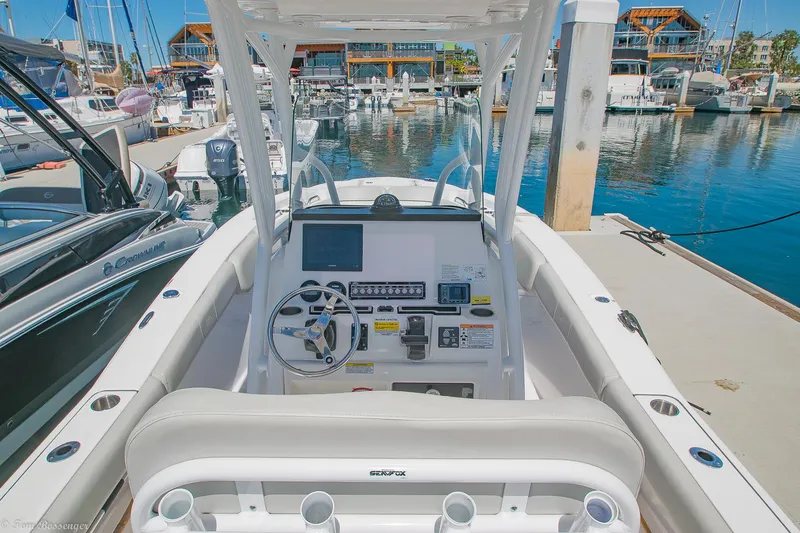 Slide: The Image of 2021 Sea Fox 248 Commander boat dashboard at marina, featuring modern controls and steering wheel. - 9