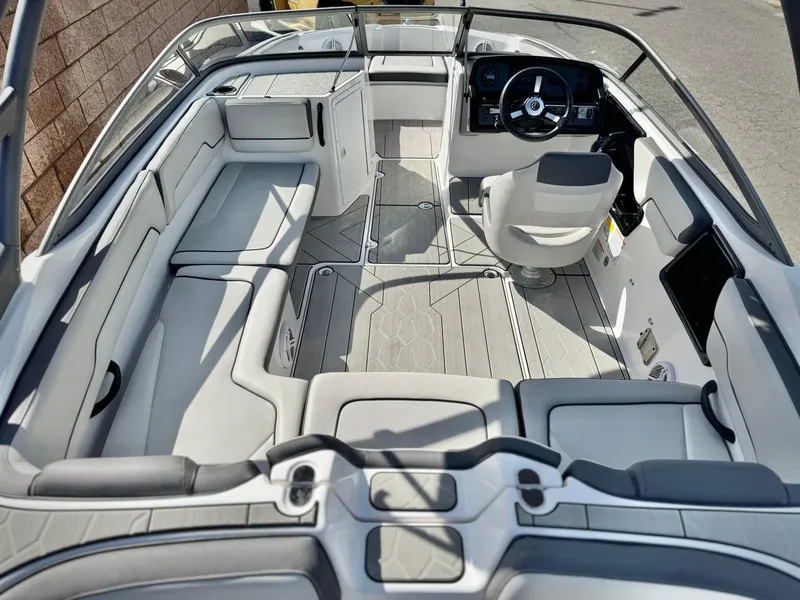 Slide: The Image of 2022 Yamaha Boats AR 190 interior with sleek seating and modern dashboard. - 10
