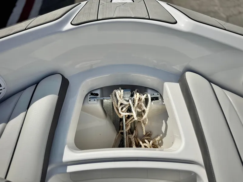 Slide: The Image of 2022 Yamaha Boats AR 190 bow storage with ropes. - 14