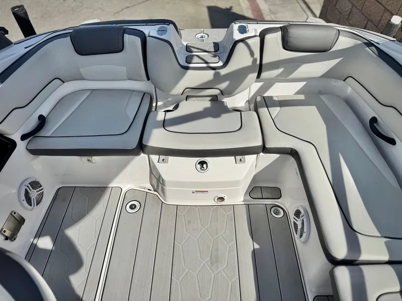 Slide: The Image of 2022 Yamaha Boats AR 190 interior with gray seating and flooring, showcasing modern design. - 16