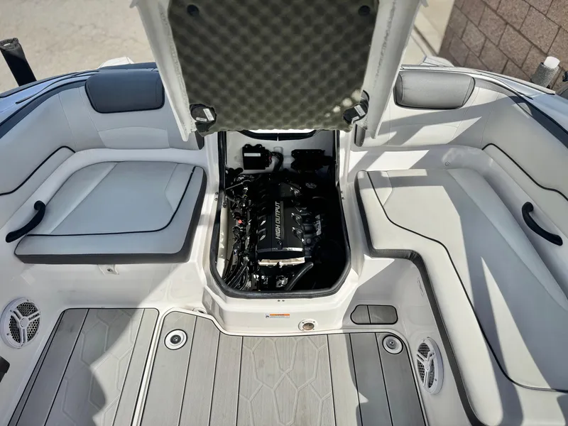 Slide: The Image of 2022 Yamaha Boats AR 190 engine compartment, open hatch, spacious seating, modern design. - 17