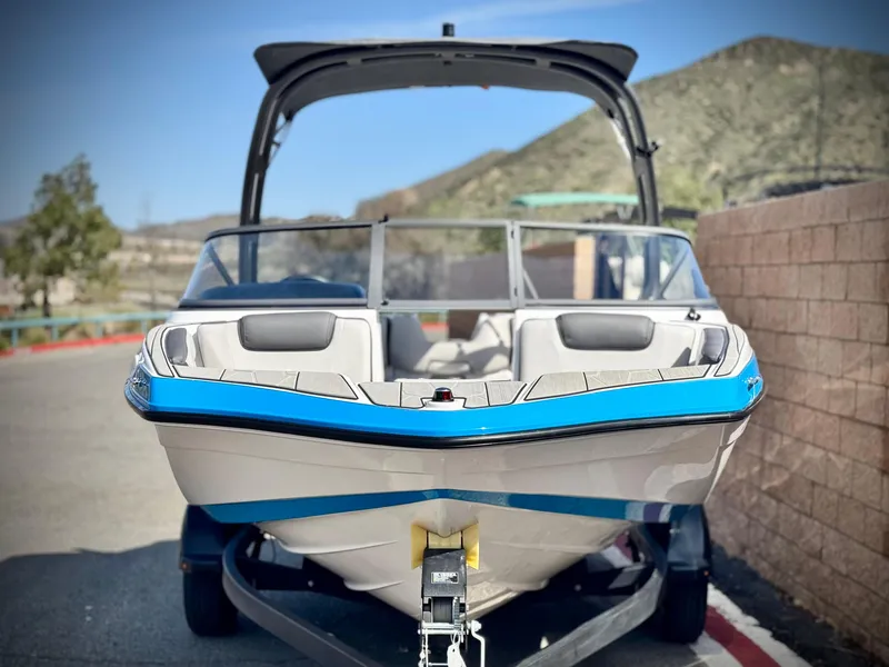 Slide: The Image of 2022 Yamaha Boats AR 190 on trailer, front view, outdoors with scenic background. - 2