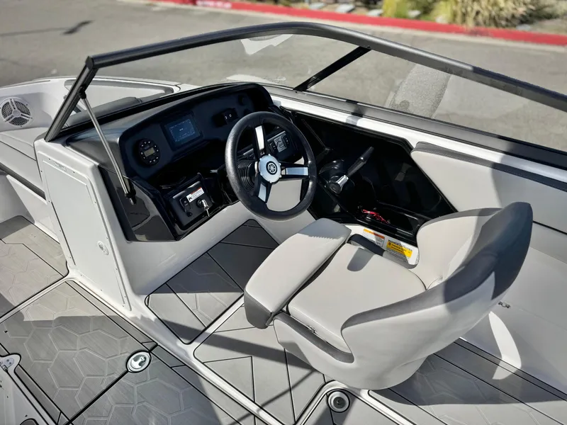 Slide: The Image of 2022 Yamaha Boats AR 190 cockpit with steering wheel and dashboard controls. - 22