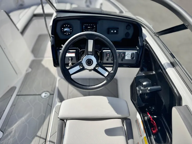 Slide: The Image of 2022 Yamaha Boats AR 190 steering console with modern controls and sleek design. - 23