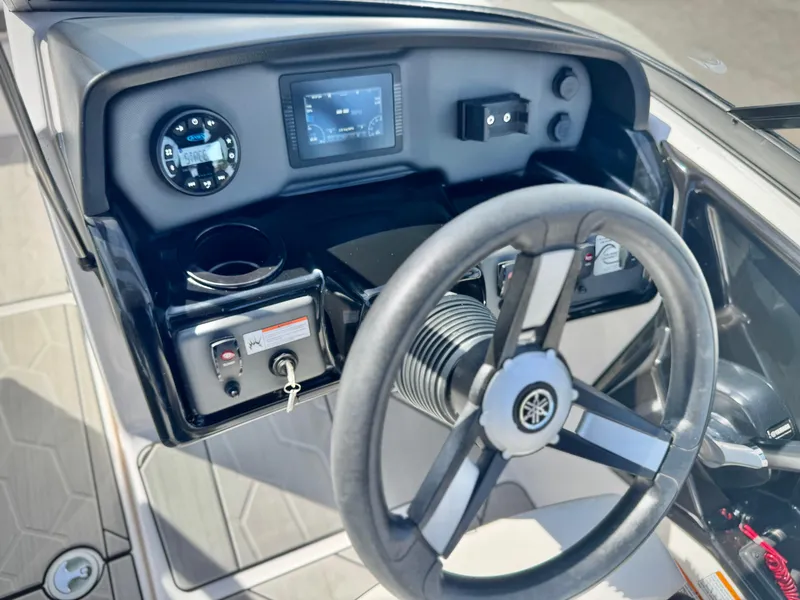 Slide: The Image of 2022 Yamaha AR 190 boat dashboard with steering wheel and control panel. - 24