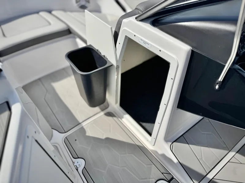 Slide: The Image of 2022 Yamaha Boats AR 190 interior with storage compartment and trash bin. - 26