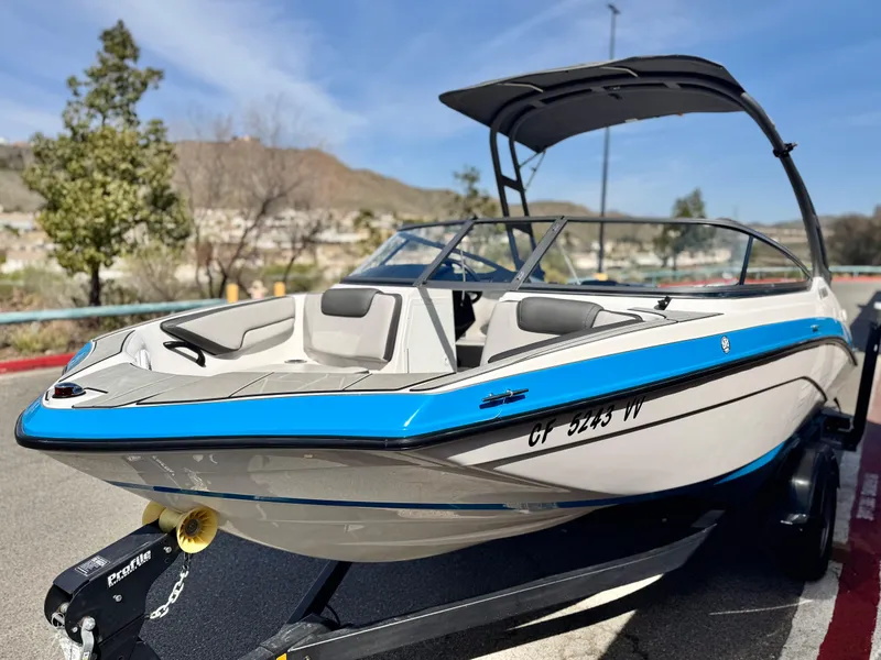 Slide: The Image of 2022 Yamaha Boats AR 190 on trailer, sleek design, blue and white color scheme. - 3
