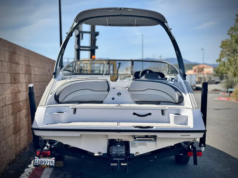 Slide: The Image of 2022 Yamaha Boats AR 190, rear view, parked outdoors on a sunny day. - 4