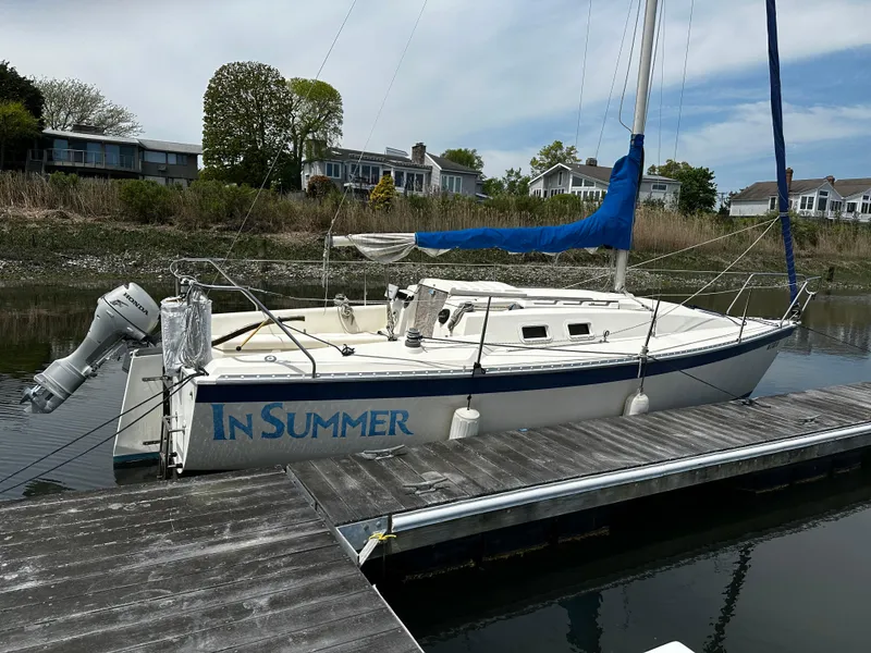 Slide: The Image of 1984 Hunter 25.5 sailboat named "In Summer" docked at a marina. - 0