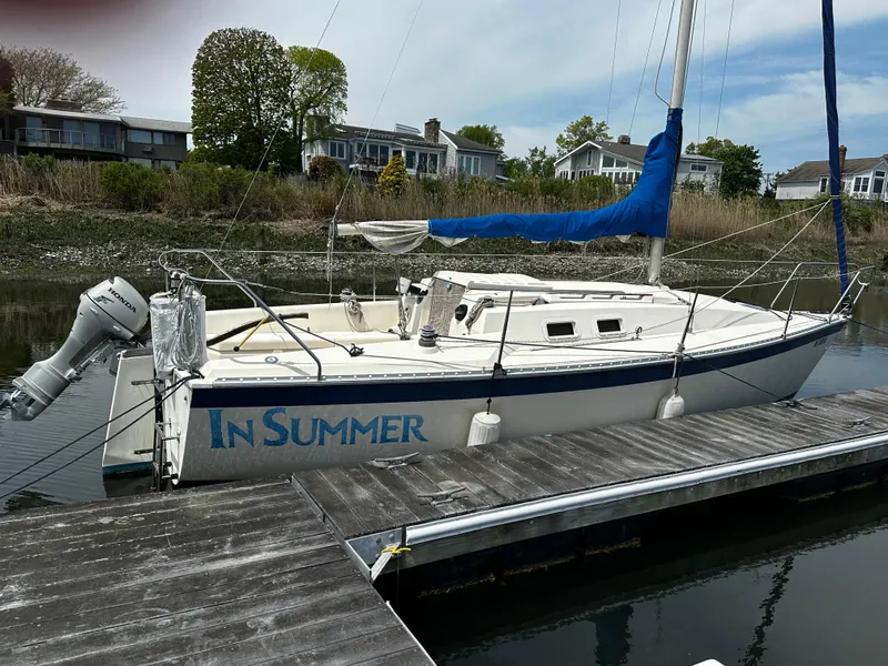 Slide: The Image of 1984 Hunter 25.5 sailboat named "In Summer" docked at a marina. - 14
