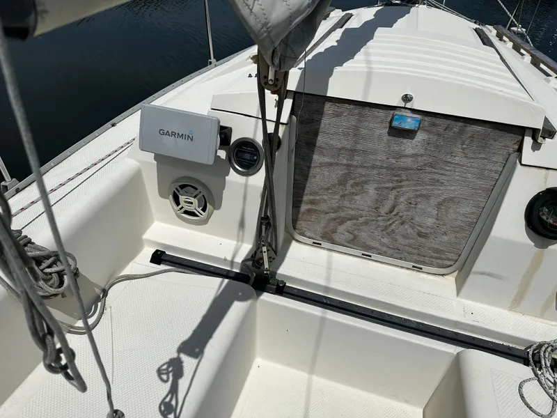 Slide: The Image of 1984 Hunter 25.5 sailboat cockpit with Garmin navigation system and wooden hatch. - 2