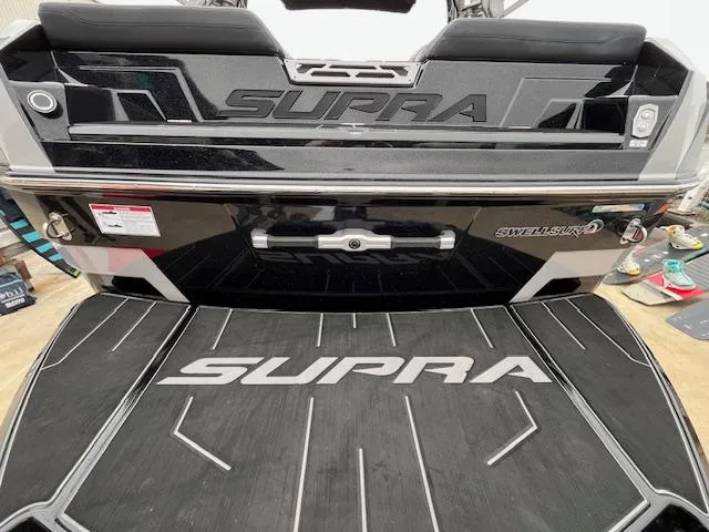 Slide: The Image of 2024 Supra SL boat rear view with logo and Swell Surf system. - 13