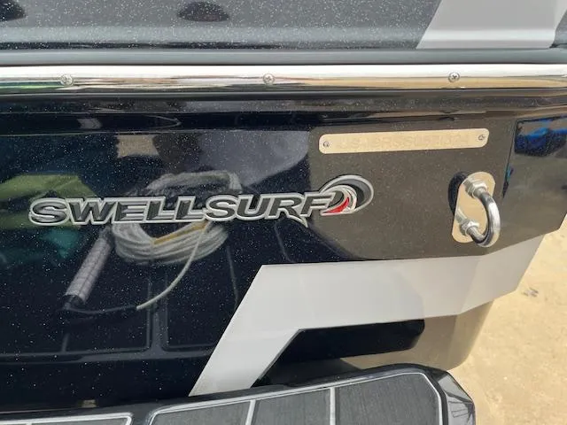 Slide: The Image of 2024 Supra SL boat with SwellSurf logo and sleek black design. - 18