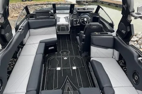 Slide: The Image of 2024 Supra SL boat interior with sleek black and white seating and modern dashboard design. - 3