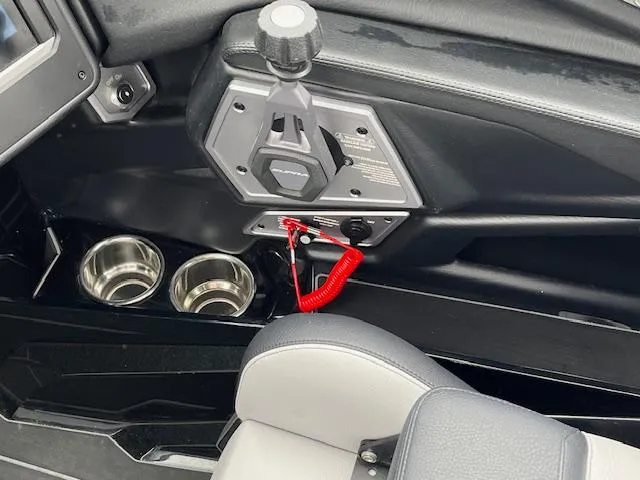 Slide: The Image of Interior of 2025 Supra SL boat with control panel and cup holders. - 8