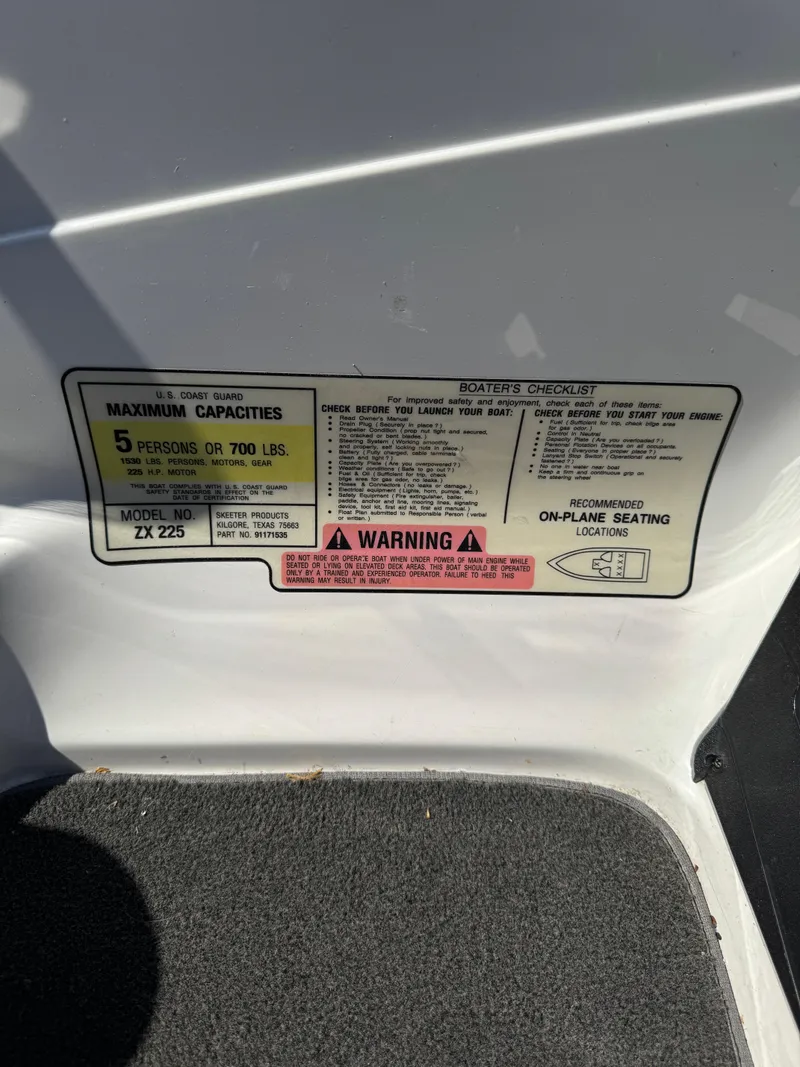 Slide: The Image of 2016 Skeeter ZX 225 capacity label, maximum 5 persons or 700 lbs, warning notice visible. - 11