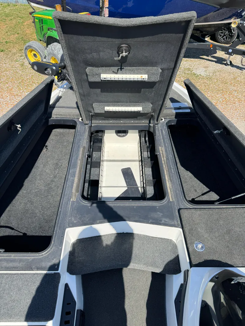 Slide: The Image of 2016 Skeeter ZX 225 boat storage compartments open, showcasing interior layout. - 12