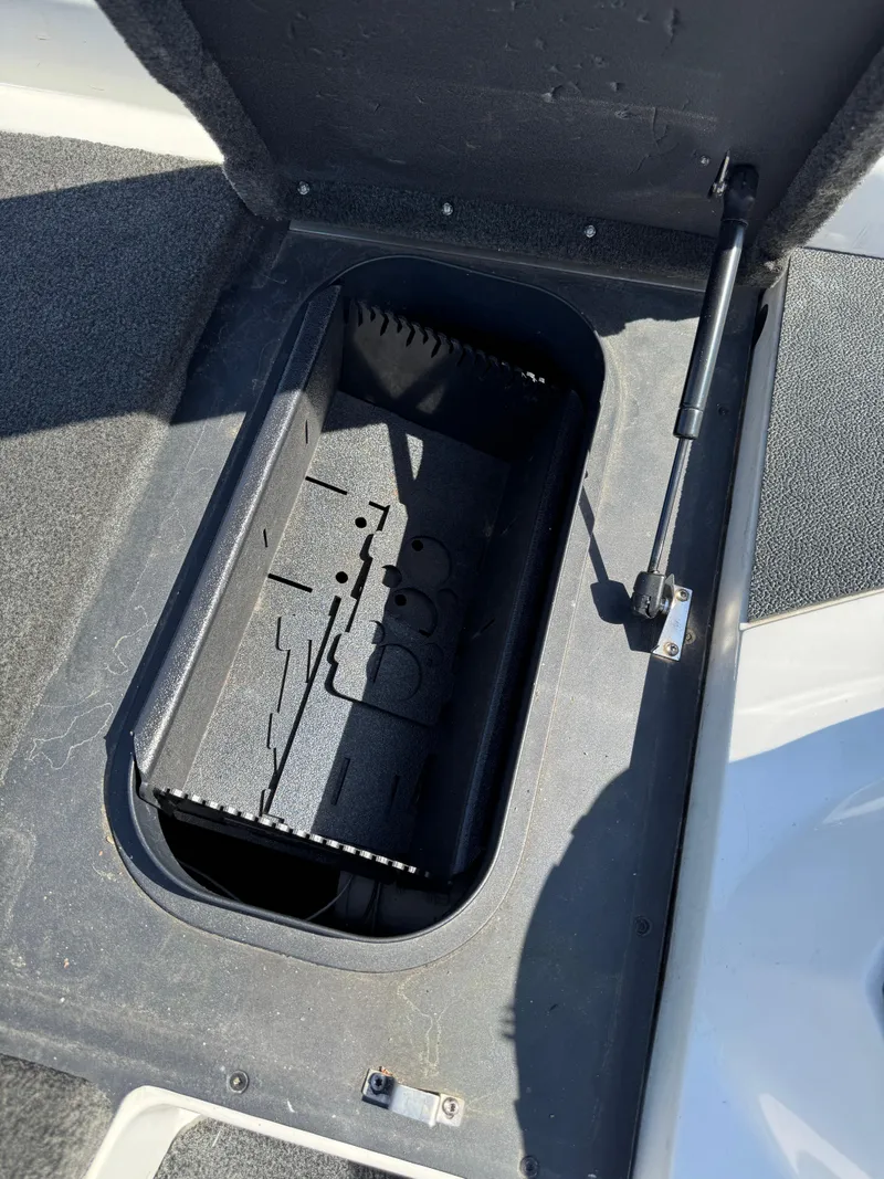 Slide: The Image of 2016 Skeeter ZX 225 boat storage compartment with open lid and hydraulic support. - 13