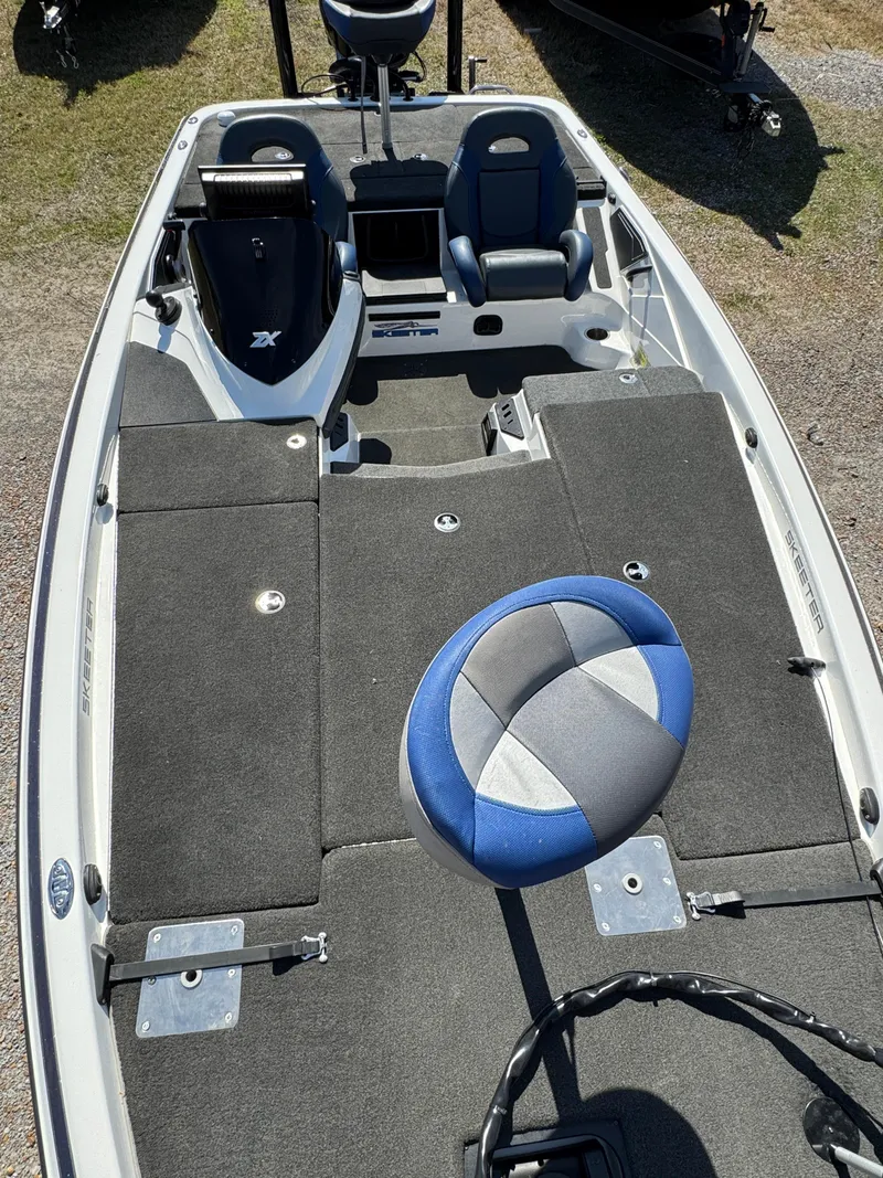 Slide: The Image of 2016 Skeeter ZX 225 fishing boat interior with seating and storage compartments. - 16