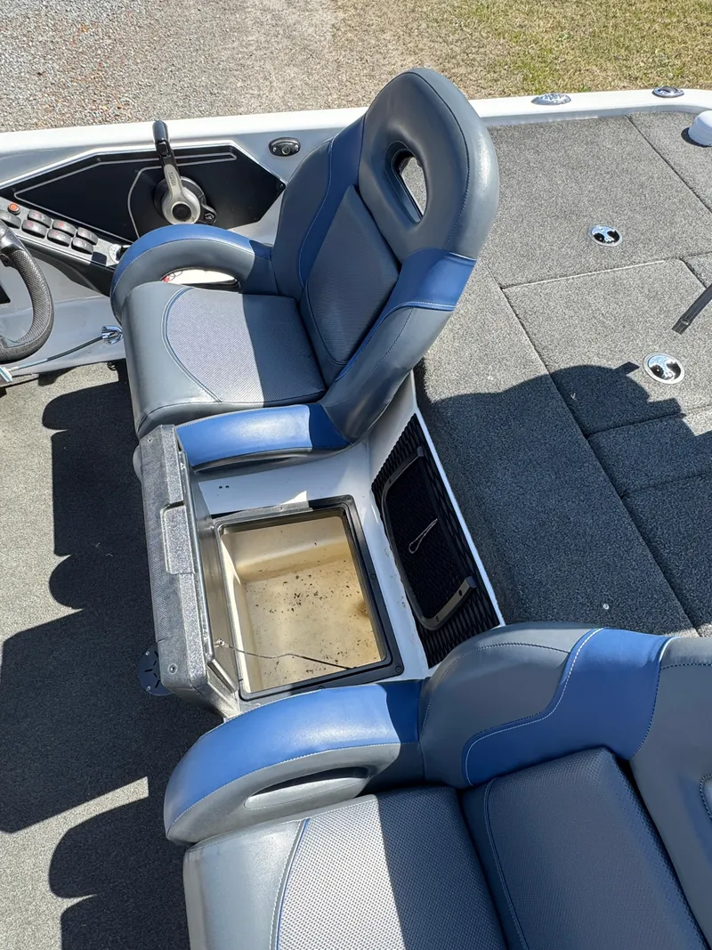 Slide: The Image of 2016 Skeeter ZX 225 boat interior with blue-gray seats and storage compartment. - 17