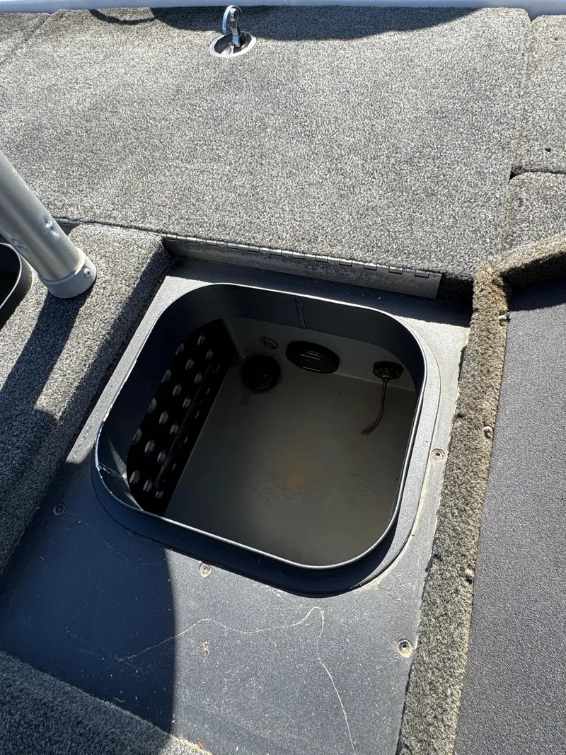 Slide: The Image of 2016 Skeeter ZX 225 boat storage compartment with open lid. - 19