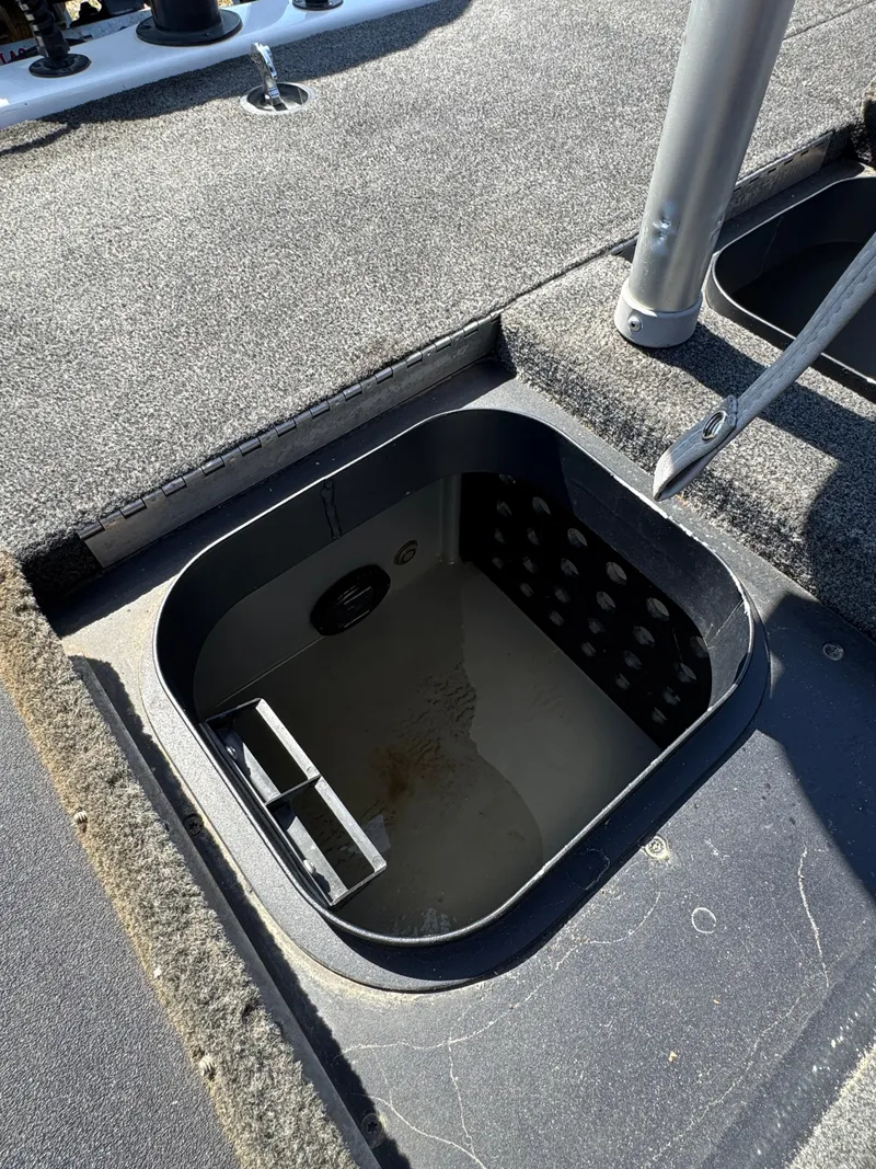 Slide: The Image of 2016 Skeeter ZX 225 boat storage compartment with open lid, showing interior details. - 20