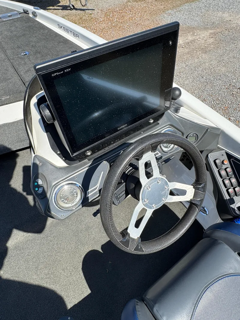 Slide: The Image of 2016 Skeeter ZX 225 boat dashboard with steering wheel and large display screen. - 21
