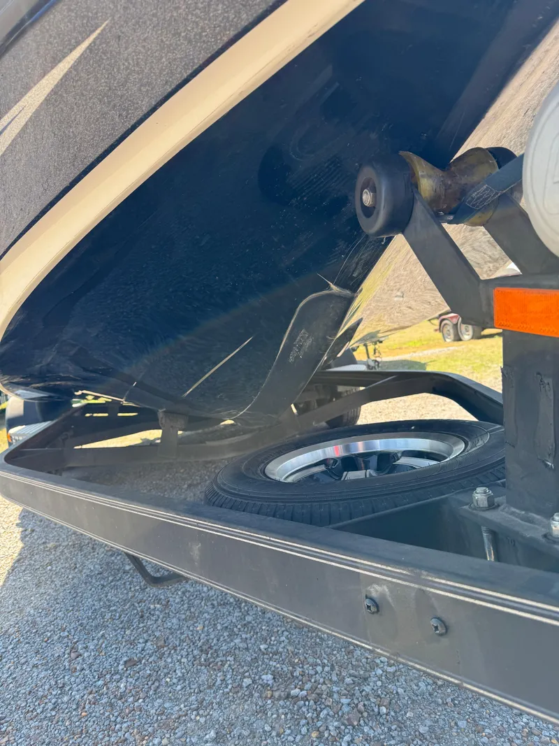 Slide: The Image of 2016 Skeeter ZX 225 boat trailer with visible wheel and undercarriage. - 23