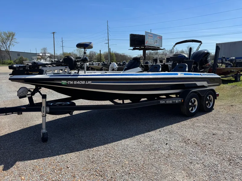 Slide: The Image of 2016 Skeeter ZX 225 bass boat on trailer in outdoor lot. - 3