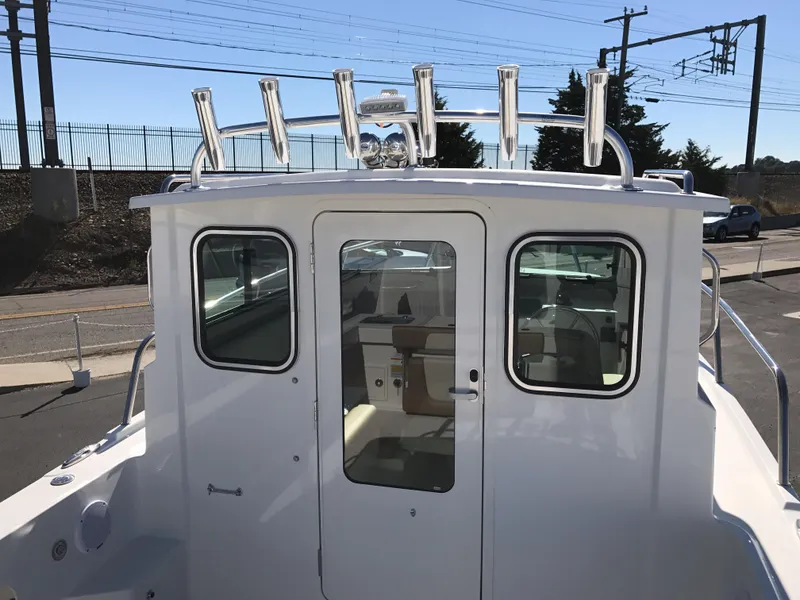 Slide: The Image of 2019 Parker 2320 SL Sport Cabin boat with rod holders and glass doors. - 10