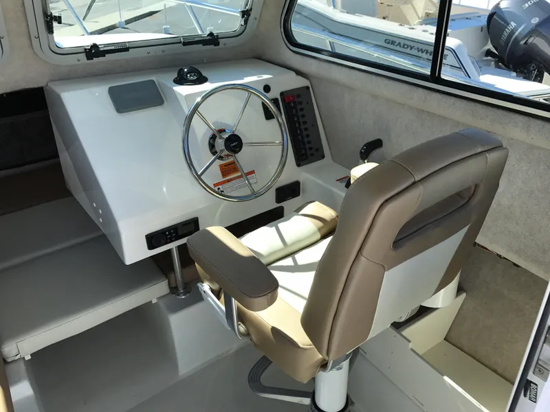 Slide: The Image of 2019 Parker 2320 SL Sport Cabin interior with steering wheel and captain's chair. - 11