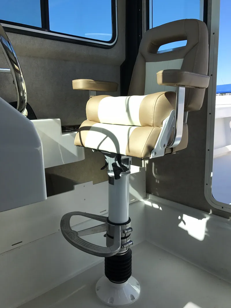 Slide: The Image of Captain's chair in 2019 Parker 2320 SL Sport Cabin boat, featuring beige upholstery and adjustable pedestal. - 13