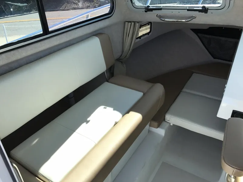 Slide: The Image of 2019 Parker 2320 SL Sport Cabin interior with cushioned seating and window view. - 14