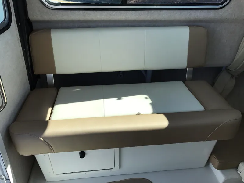 Slide: The Image of 2019 Parker 2320 SL Sport Cabin interior seating with beige and white upholstery. - 15
