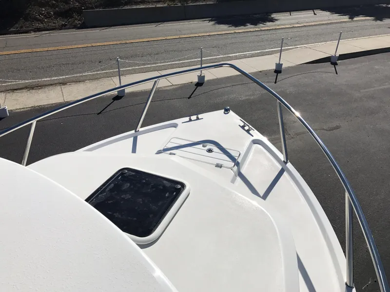 Slide: The Image of 2019 Parker 2320 SL Sport Cabin boat deck with railing and hatch. - 19