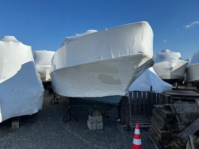 Slide: The Image of 2019 Parker 2320 SL Sport Cabin boat covered in protective wrap, stored outdoors. - 21