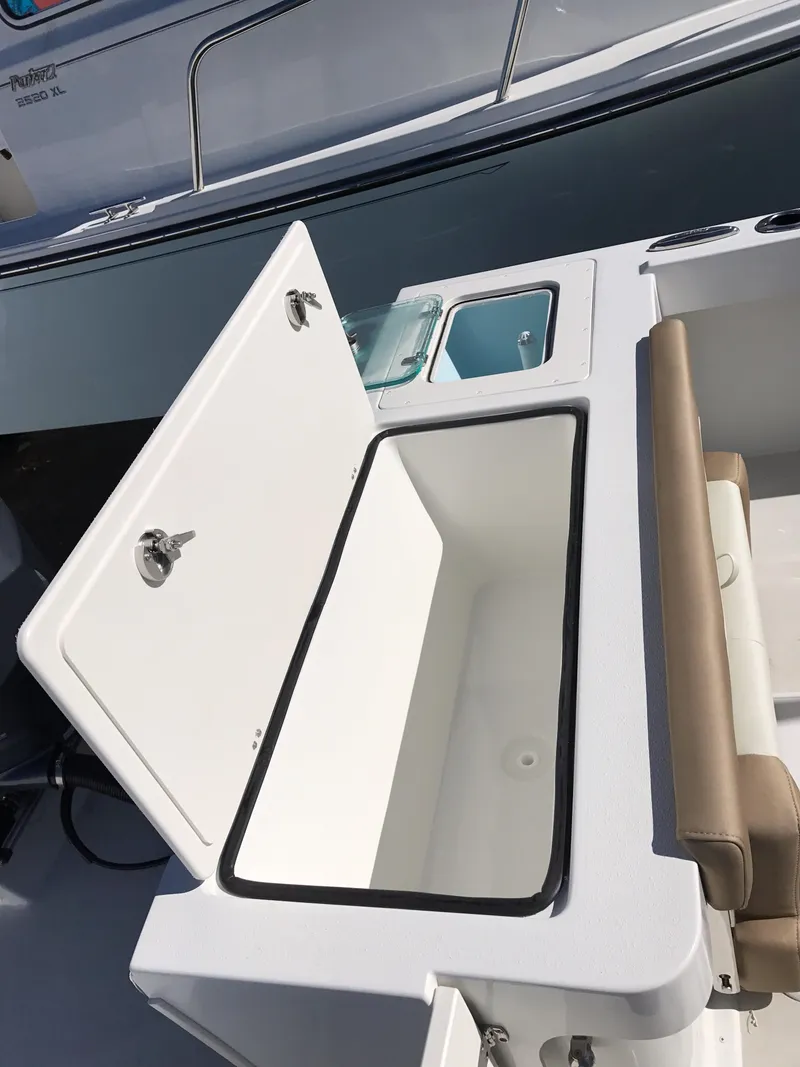 Slide: The Image of 2019 Parker 2320 SL Sport Cabin boat with open storage compartment and seating area. - 9