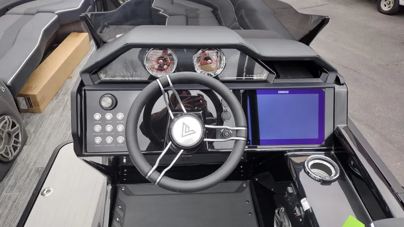 Slide: The Image of 2025 Viaggio Diamante boat dashboard with steering wheel, gauges, and touchscreen display. - 16