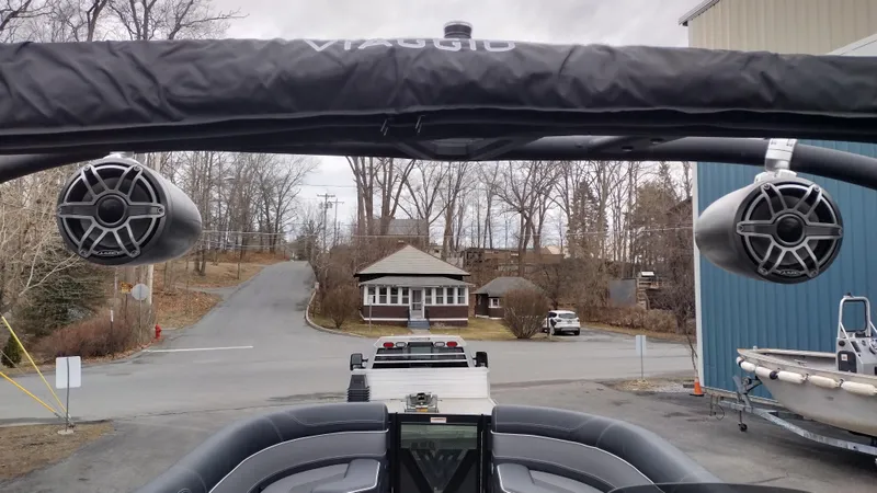 Slide: The Image of 2025 Viaggio Diamante boat with speakers, parked near a road and building. - 25