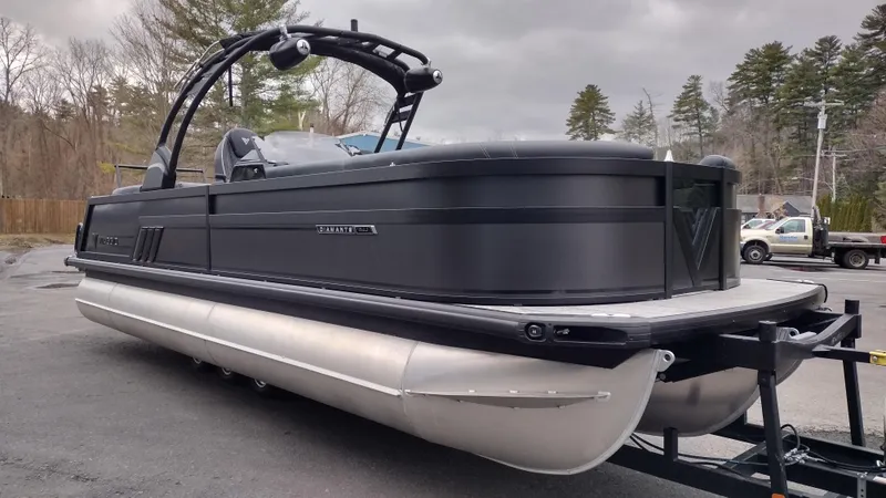 Slide: The Image of 2025 Viaggio Diamante pontoon boat on trailer, sleek black design, parked outdoors. - 4