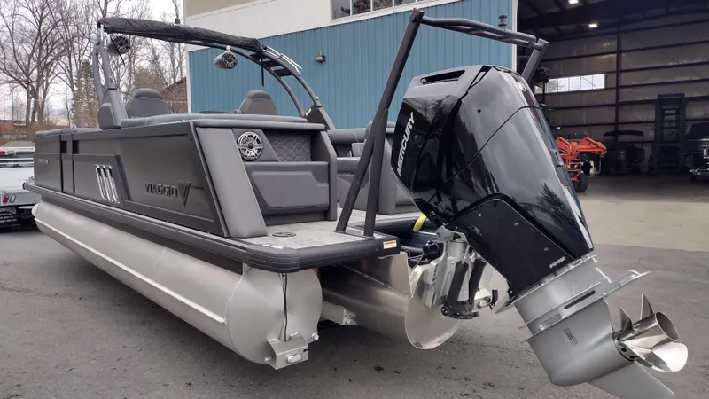 Slide: The Image of 2025 Viaggio Diamante pontoon boat with powerful outboard motor, parked outdoors. - 8