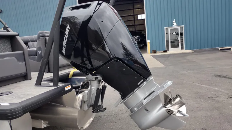 Slide: The Image of Outboard motor on a Viaggio Diamante 2025 boat, parked near a blue building. - 9