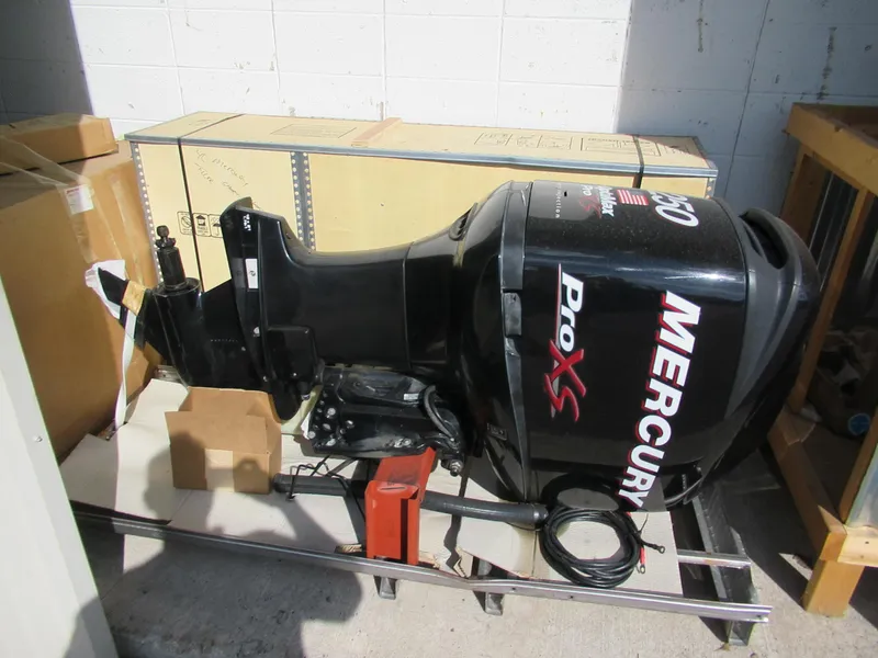 Slide: The Image of 2009 Mercury 250L OPTI MAX outboard motor in storage, black with Pro XS branding. - 1