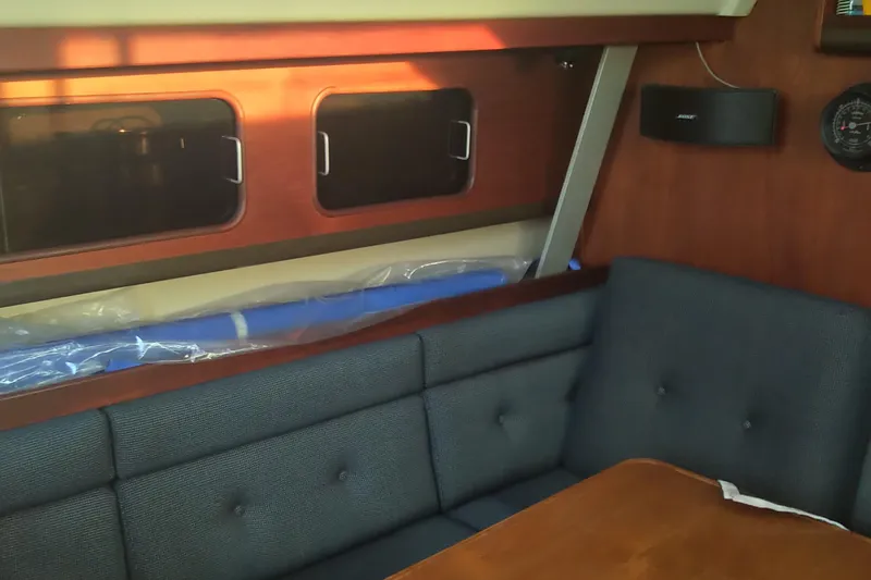 Slide: The Image of Interior of 1984 C&C 35 MK III sailboat with cushioned seating and wooden table. - 10
